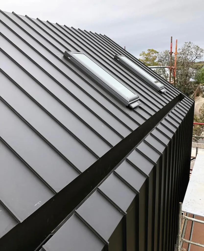 Exterior cladding extending from roof to wall, creating a seamless modern design — by Cladding Wellington.