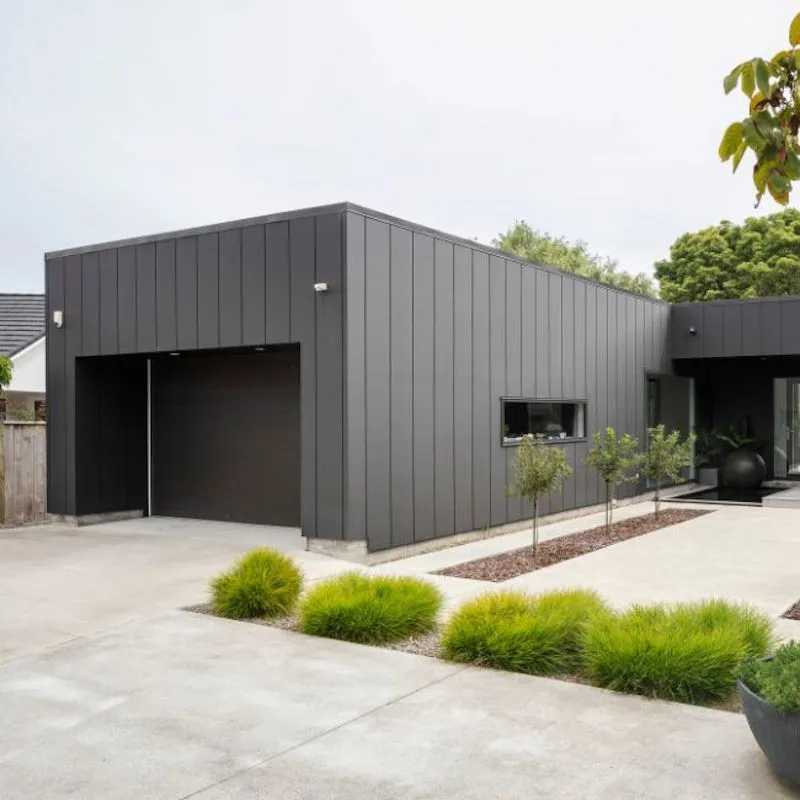 Professional cladding installation on a multi-level home, using modern materials to improve weather resistance and curb appeal — by Cladding Wellington.