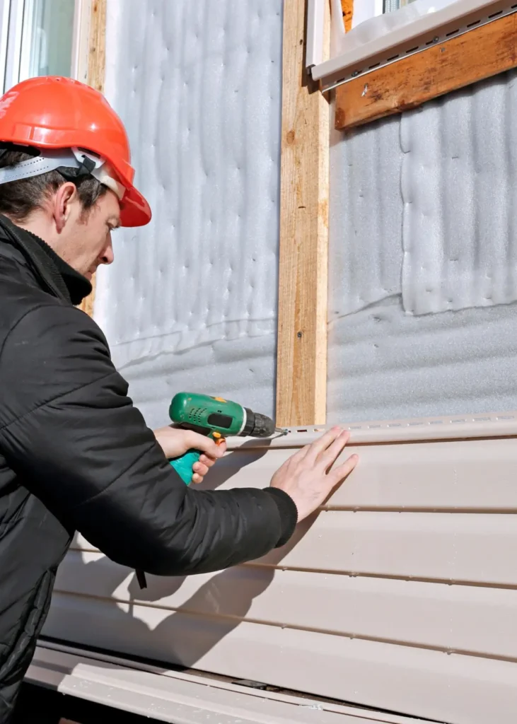 House undergoing recladding, with new materials being installed for enhanced protection and appearance — by Cladding Wellington.