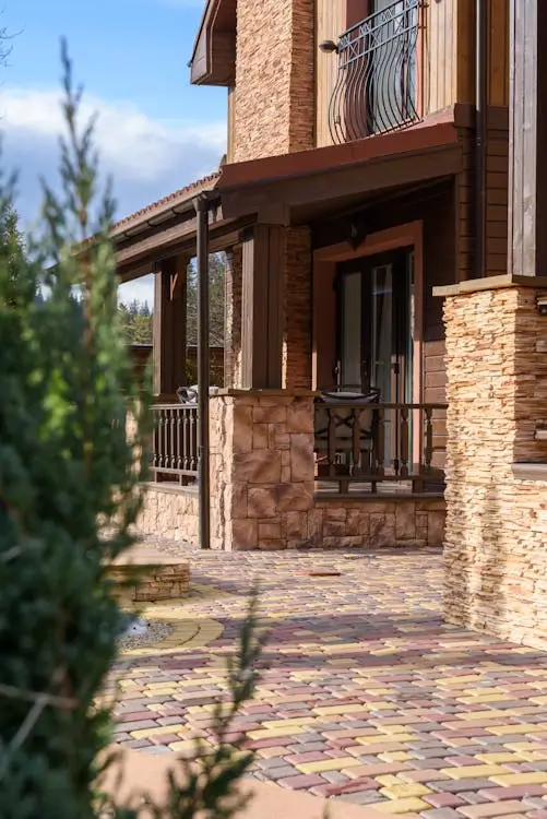House wall covered with stone cladding, providing a modern and textured exterior finish — by Cladding Wellington.